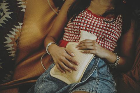Woman with hot water bottle