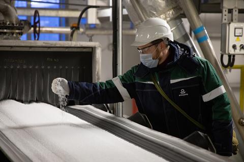 Worker inspecting fertiliser
