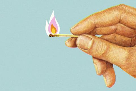 Hand holding matchstick