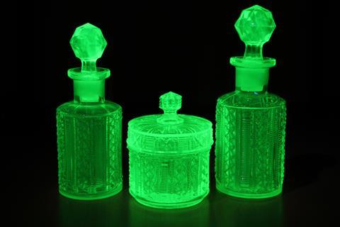 Art deco molded green uranium glass fluoresces under UV light