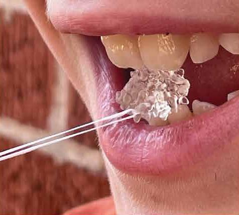 An image showing a close-up of a person's mouth with a tiny transparent protein model clamped between their teeth