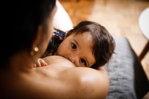 An image showing a mother feeding her baby