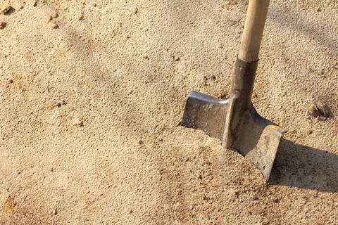 shovel digging up sand
