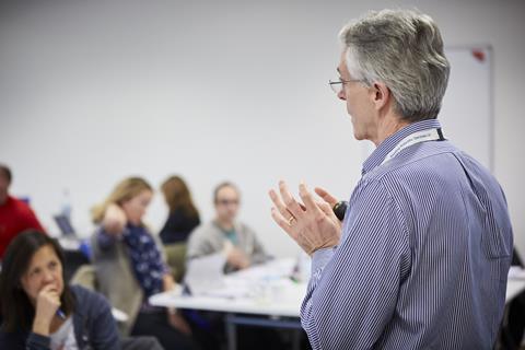 A man delivers a talk at a workshop