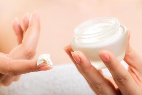 Woman using face cream