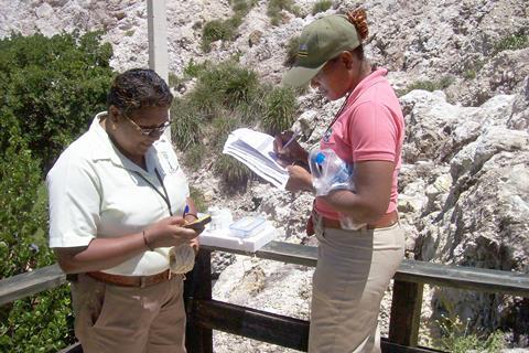 A photo of scientist in the field taking samples