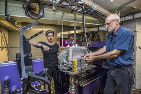 An image of Jackie Gates, left, and Ken Gregorich, work on FIONA during its early commissioning in 2017