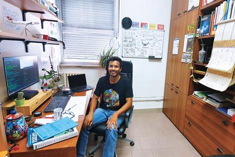 A photograph showing Jose Flroes-Livas in his office