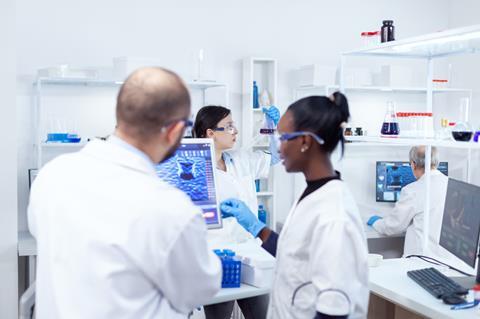 Laboratory scientists review results on screen