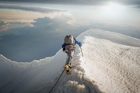 An image showing a person climbing a mountain