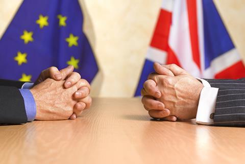 An image showing hands, EU and UK flags