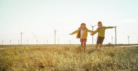 Children playing near a wind turbine