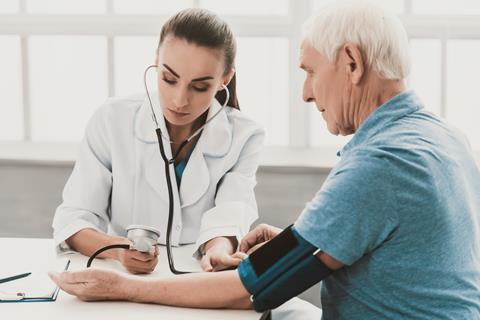 A doctor taking a patient's blood pressure