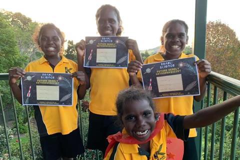 An image showing a group of children holding diplomas