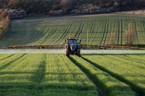 Agriculture - A farmer spraying fertilizer on his crops - North Yorkshire - England.