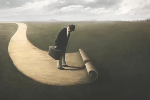A man stands at the end of a path, as it unrolls further in front of him