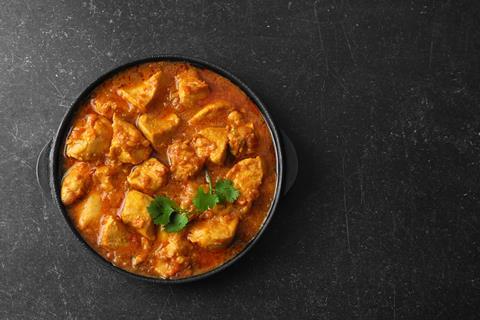 Bowl of curry on a dark table 