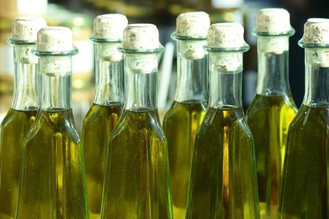 Home-made olive oil in bottles on a market