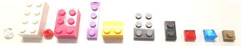 A selection of different coloured and shaped plastic toy bricks