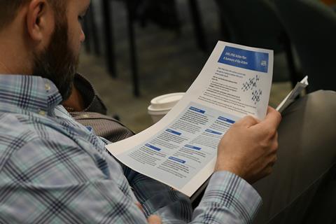An image showing a man holding a piece of paper which highlights EPA's PFAS action plan