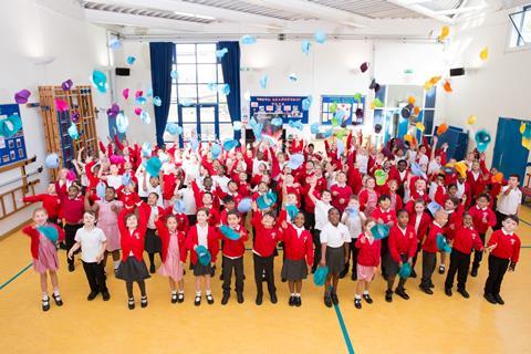 An image showing children throwing periodic table hats