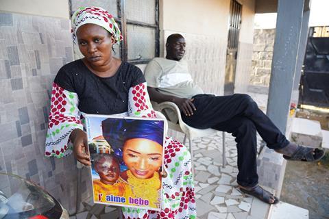 Woman holding a picture of her baby