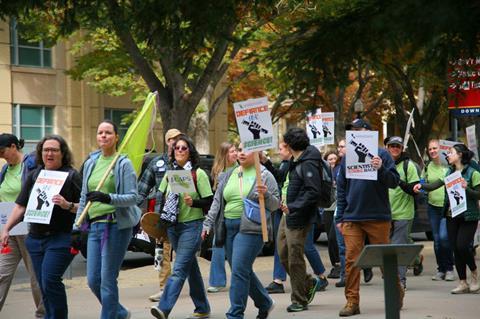 People marching in a protest with placards that say Defiance for Science