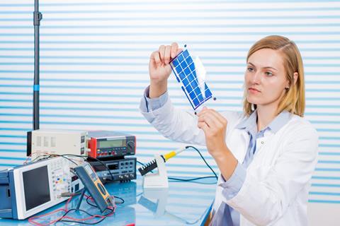 a technician testing film solar cells
