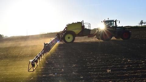 An image showing an agricultural tractor spraying glyphosate
