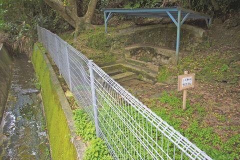 An image showing a sign posted by town officials to warn people not to drink nearby polluted spring water is pictured in Kadena, Okinawa, Friday, May 10, 2019