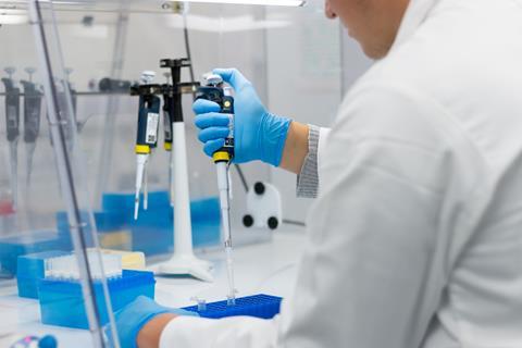 PrimerDesign lab worker transferring liquid using a pipette