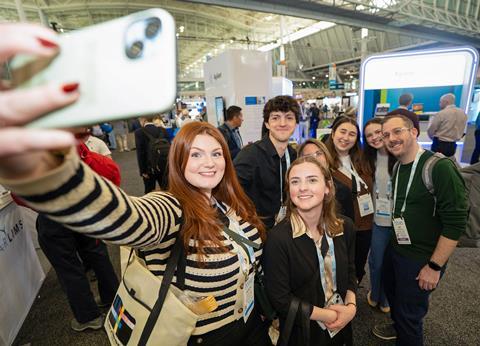 Group of conference attendees smiling taking a selfie
