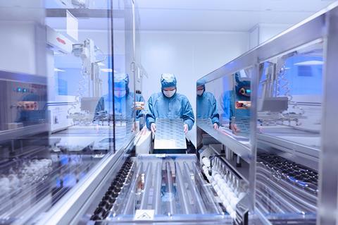 Worker in PPE in cleanroom