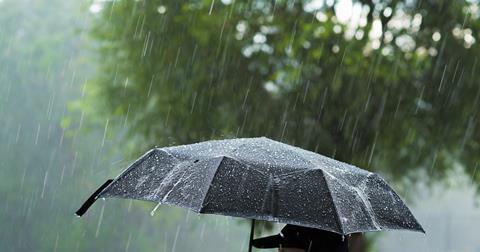 Heavy rain on a black umbrella