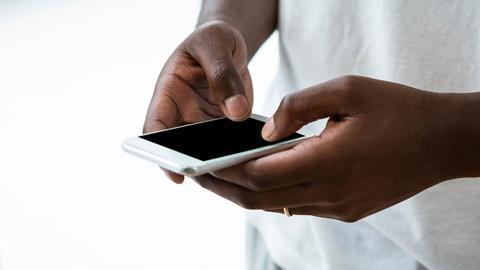 An image showing a man using a mobile phone