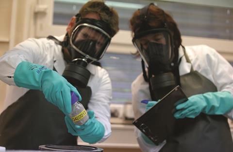 WIS employees testing dummy chemical weapons sample in OPCW laboratory