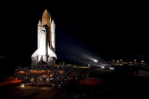 Bathed in xenon lights, space shuttle Atlantis embarks on its final journey from the Vehicle Assembly Building to Launch Pad 39A at NASA's Kennedy Space Center in Florida.