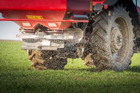 Tractor fertilizing wheat field