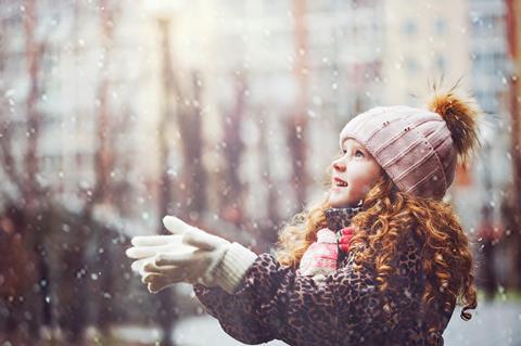A young girl catching falling snow