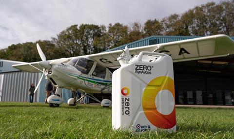 A can of fuel with a small plane behind