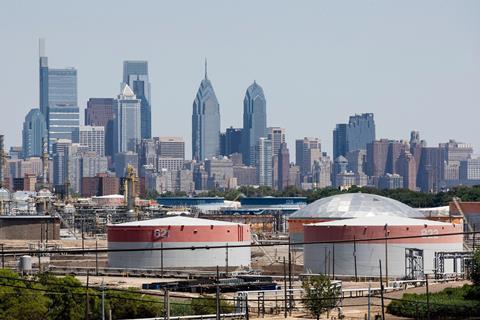 An oil refinery with a city in the background