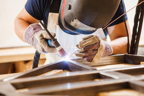 A photograph of a person welding using an argon arc