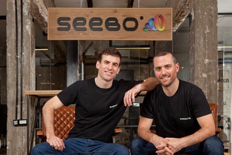 Liran and Lior Akavia seated in front of a Seebo sign