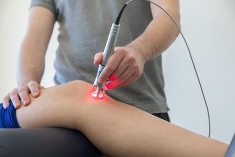 Laser therapy being used to treat knee pain