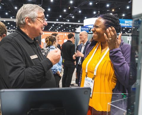 Two attendees at the Pittcon conference in an animated conversation