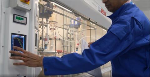 Scientist monitoring equipment in lab