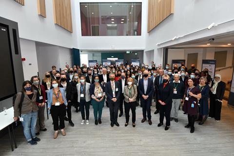 An image showing a group photo of people wearing face masks