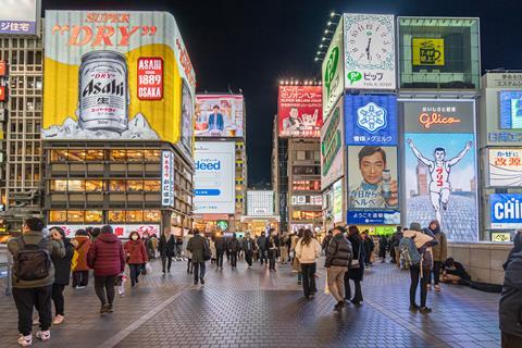 A crowd of people in night shopping street at Dotonbori, Osaka, Japan