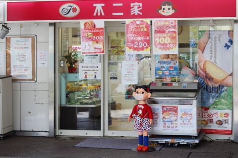 A Fujiya confectionary store in Tokyo with its mascot Peko wearing a mask