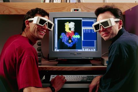 An image showing researchers with 3D glasses in front of molecular model